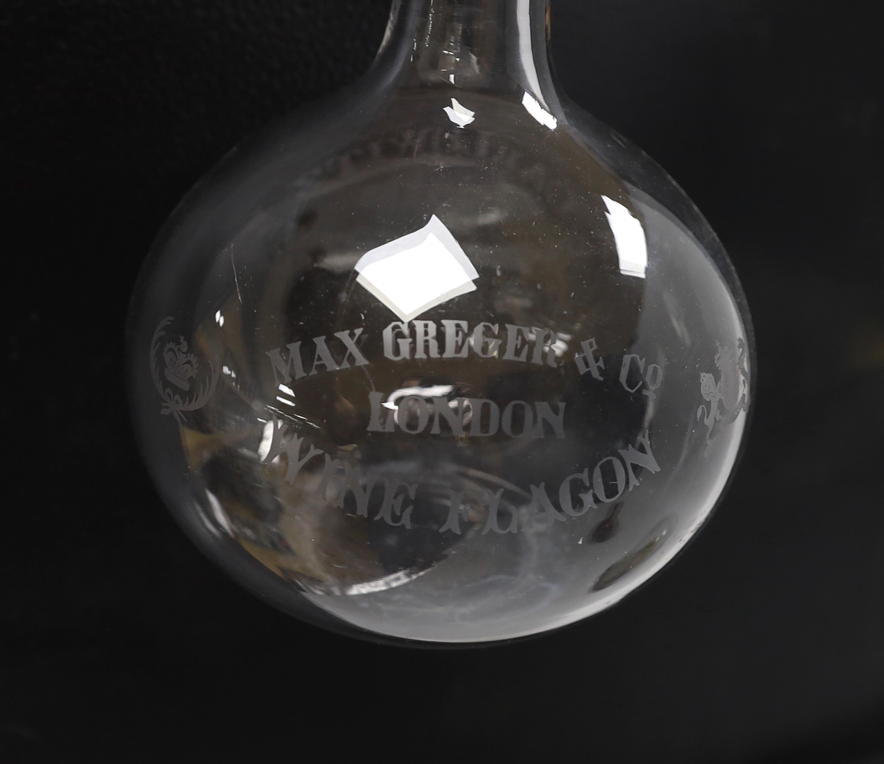 A large engraved, “Max Greger & Co London Wine Flagon”, a small amber glass bottle 1891 and a figural wax sculpture under dome, tallest flagon 26cm high